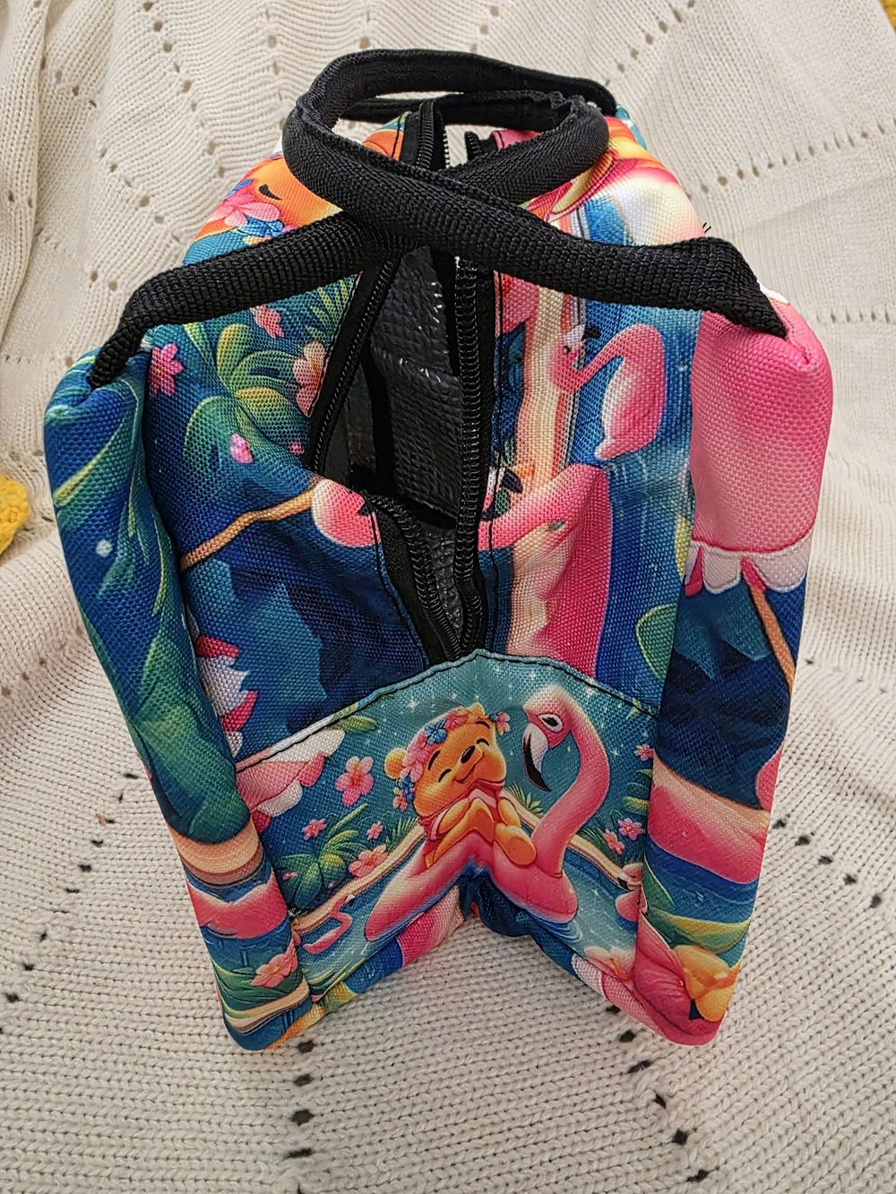 Insulated lunch bag features a playful design of Winnie the Pooh wearing a color